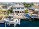 Waterfront home featuring a boat lift, private dock, and outdoor entertaining area with lush landscaping at 4058 Centavo Ct, Hernando Beach, FL 34607