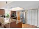 Functional kitchen with stainless steel refrigerator, wood cabinets, and granite countertops at 4058 Centavo Ct, Hernando Beach, FL 34607