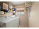 Functional laundry room with washer, dryer, storage shelves, and a window for natural light at 4058 Centavo Ct, Hernando Beach, FL 34607