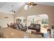 Inviting living room with nautical decor, vaulted ceiling, and comfortable leather seating at 4058 Centavo Ct, Hernando Beach, FL 34607