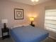 This bedroom features a plush bed with side tables and lamps for a calm and relaxing atmosphere at 4096 Everett Ave, Spring Hill, FL 34609