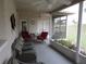 Covered porch with ceiling fan, comfortable seating, and serene outdoor views at 4096 Everett Ave, Spring Hill, FL 34609
