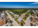 Scenic aerial view of a quiet neighborhood with lush greenery and single-Gathering homes near the coast at 4107 Glissade Dr, New Port Richey, FL 34652