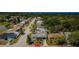 An aerial shot showcasing the neighborhood with lush greenery, nearby lake, and the home's proximity to nature at 4107 Glissade Dr, New Port Richey, FL 34652