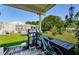 Backyard featuring a grill, seating, bicycle, and lush green grass at 4107 Glissade Dr, New Port Richey, FL 34652