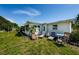 Inviting backyard with outdoor seating area and well-maintained lawn at 4107 Glissade Dr, New Port Richey, FL 34652
