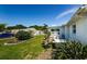 Backyard with outdoor seating, lawn and shade trees at 4107 Glissade Dr, New Port Richey, FL 34652