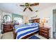 Well-lit bedroom features dark wood furniture, soft lighting, and decorative wall art at 4107 Glissade Dr, New Port Richey, FL 34652