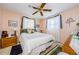 Cozy bedroom features a ceiling fan, two windows, and a comfortable queen sized bed at 4107 Glissade Dr, New Port Richey, FL 34652