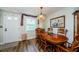 Dining area featuring hardwood floors and a decorative chandelier at 4107 Glissade Dr, New Port Richey, FL 34652