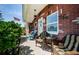 Inviting covered porch with brick facade and comfortable seating area at 4107 Glissade Dr, New Port Richey, FL 34652