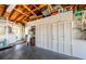 Well-organized garage has white storage cabinets along one wall with door to laundry room at 4107 Glissade Dr, New Port Richey, FL 34652