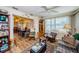 A cozy living room that flows into the dining room, featuring wood floors and natural light at 4107 Glissade Dr, New Port Richey, FL 34652