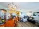 Open concept living and dining room area with wood floors and an elegant chandelier at 4107 Glissade Dr, New Port Richey, FL 34652