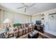 Inviting living room featuring a plaid sofa, a decorative fireplace, and ample natural light at 4107 Glissade Dr, New Port Richey, FL 34652