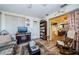 Comfortable living room with plaid sofa, wood floors, and an electric fireplace at 4107 Glissade Dr, New Port Richey, FL 34652