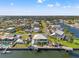Wide aerial view showcasing a charming waterfront neighborhood, abundant canals, and neatly maintained properties at 4207 Carlos Ct, Hernando Beach, FL 34607