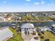 Expansive view of a waterfront community featuring homes along canals, ample parking, and tropical landscaping at 4207 Carlos Ct, Hernando Beach, FL 34607