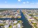 Overhead captures an extensive network of canals and the waterfront homes with boat docks dotting the landscape at 4207 Carlos Ct, Hernando Beach, FL 34607
