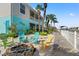 Inviting backyard space featuring a patio with outdoor seating, tropical landscaping, and waterfront access at 4207 Carlos Ct, Hernando Beach, FL 34607