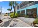 Waterfront property featuring a covered patio, tropical landscaping, and a private dock for easy access to the water at 4207 Carlos Ct, Hernando Beach, FL 34607