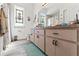 Bathroom featuring a long vanity with stained glass window and wood-look luxury vinyl plank flooring at 4207 Carlos Ct, Hernando Beach, FL 34607