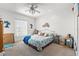Bright bedroom featuring a ceiling fan, tropical decor and a comfortable bed with blue accents at 4207 Carlos Ct, Hernando Beach, FL 34607