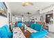 Bright dining area featuring turquoise chairs, ceiling fan, and open floor plan at 4207 Carlos Ct, Hernando Beach, FL 34607