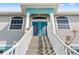 Stairs lead to the home's inviting entryway, featuring detailed double doors and a color-coordinated trim at 4207 Carlos Ct, Hernando Beach, FL 34607