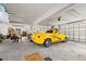 Large garage showing yellow SSR, overhead lights, and garage doors at 4207 Carlos Ct, Hernando Beach, FL 34607