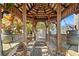 Wooden gazebo with bench seating offering shade and a peaceful spot in the backyard at 4207 Carlos Ct, Hernando Beach, FL 34607