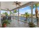 Inviting lanai featuring tile floors, ceiling fans, and beautiful waterfront views of the canal at 4207 Carlos Ct, Hernando Beach, FL 34607