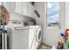 Well-lit laundry room equipped with modern washer and dryer at 4207 Carlos Ct, Hernando Beach, FL 34607