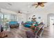 Spacious living room with sliding glass doors, ceiling fans and wood flooring at 4207 Carlos Ct, Hernando Beach, FL 34607