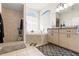 Main bathroom with soaking tub, walk-in shower, and & sinks at 4207 Carlos Ct, Hernando Beach, FL 34607
