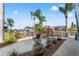 Beautifully landscaped patio with lounge chairs, outdoor grill, and waterfront views at 4207 Carlos Ct, Hernando Beach, FL 34607