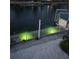 Waterfront features green lighting at the canal-front property, offering scenic views and enhanced outdoor ambiance at 4207 Carlos Ct, Hernando Beach, FL 34607