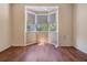 Bedroom featuring hardwood floors and a charming bay window with shades at 4225 La Pasida Ln, New Port Richey, FL 34655