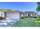 Home with brick accents, well maintained lawn and mature landscaping at 4402 Grandwood Ln, New Port Richey, FL 34653