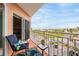 Relaxing balcony featuring a chair, table, and views of the beach and surrounding scenery at 4516 Seagull Dr # 509, New Port Richey, FL 34652