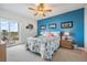 Comfortable bedroom with a queen bed, balcony access, and a bright blue accent wall at 4516 Seagull Dr # 509, New Port Richey, FL 34652