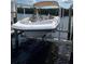 Boat on lift shows easy water access for this waterfront property at 4516 Seagull Dr # 509, New Port Richey, FL 34652