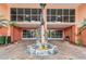 Building entrance with dolphin statue as focal point at 4516 Seagull Dr # 509, New Port Richey, FL 34652
