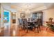Dining area featuring an elegant chandelier, wood floors, and a classic display cabinet with an open view at 4516 Seagull Dr # 509, New Port Richey, FL 34652