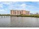 A picturesque view of a condominium complex with a bridge over the water at 4516 Seagull Dr # 509, New Port Richey, FL 34652