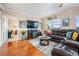 Cozy living room with hardwood floors, fireplace, and comfortable leather seating area, complete with nautical decor at 4516 Seagull Dr # 509, New Port Richey, FL 34652