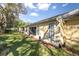 Spacious backyard with lush green grass, mature landscaping, and comfortable outdoor living at 4831 Wakefield Ct, New Port Richey, FL 34655