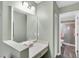 Bathroom with vanity counter and mirror and open door to shower and toilet area at 4831 Wakefield Ct, New Port Richey, FL 34655
