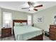 Bedroom with gray flooring, a ceiling fan, shutters and earth tone furniture at 4831 Wakefield Ct, New Port Richey, FL 34655