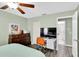 Comfortable bedroom with desk, television, ceiling fan, and ensuite bathroom at 4831 Wakefield Ct, New Port Richey, FL 34655